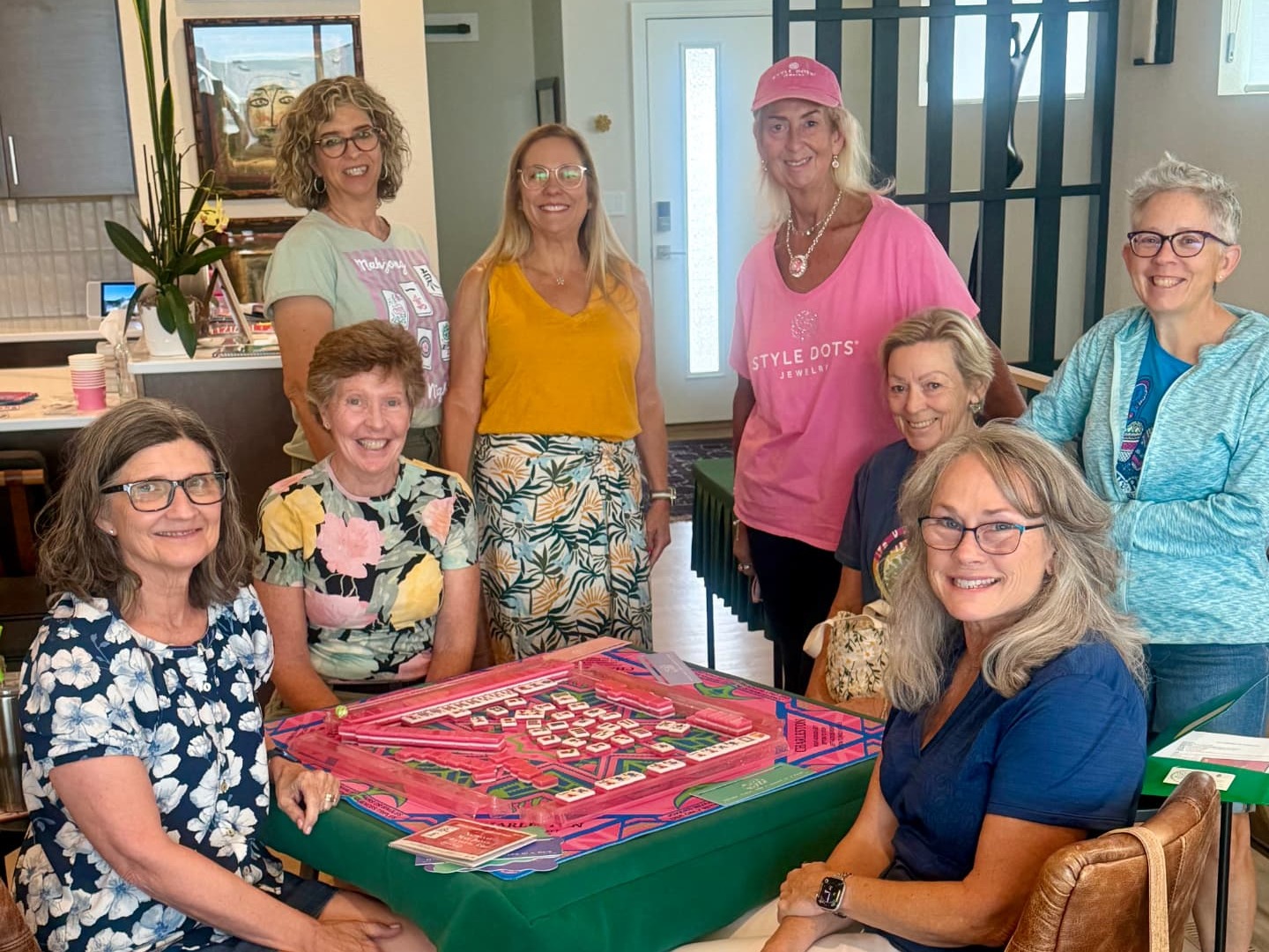 A group of players gathered around a Mahjong table at Amy's Mahjong House