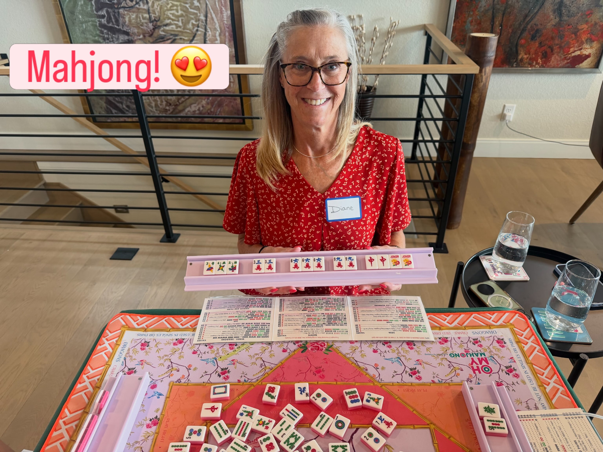 Diane smiling while holding her Mahjong rack
